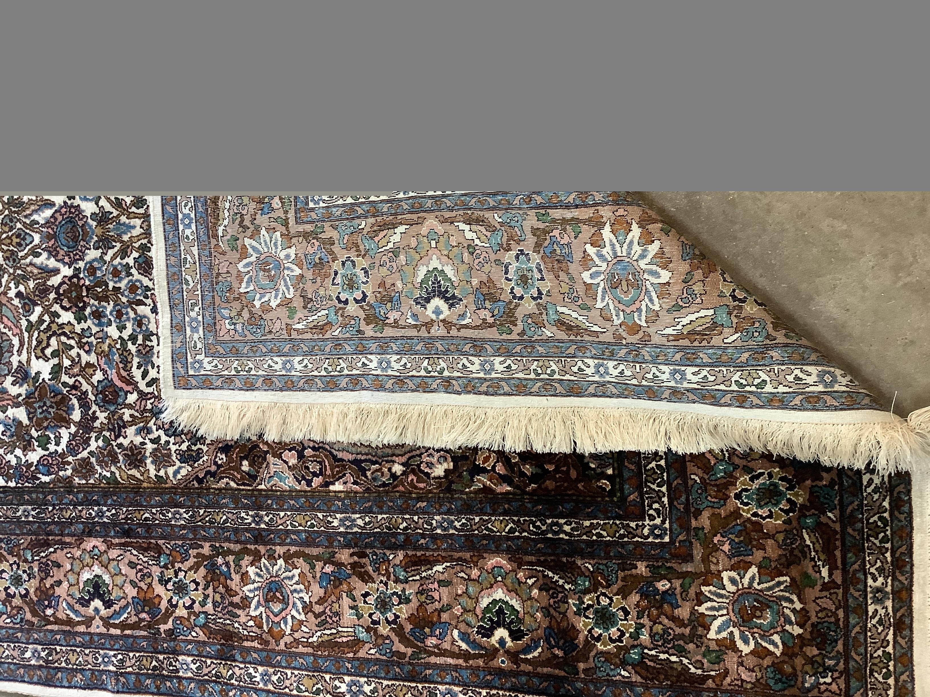 A North West Persian ivory ground rug, 220 x 136cm